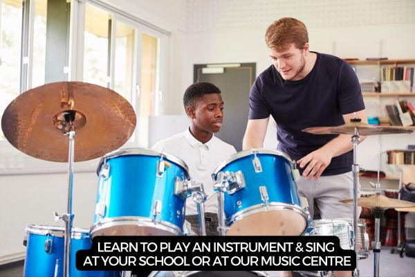 Pupil having a music lesson on a drum kit