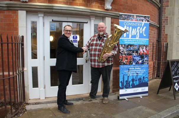 Mark A handing over instruments to Brass 4 Africa