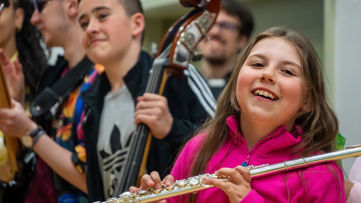 young people playing classical musical instruments