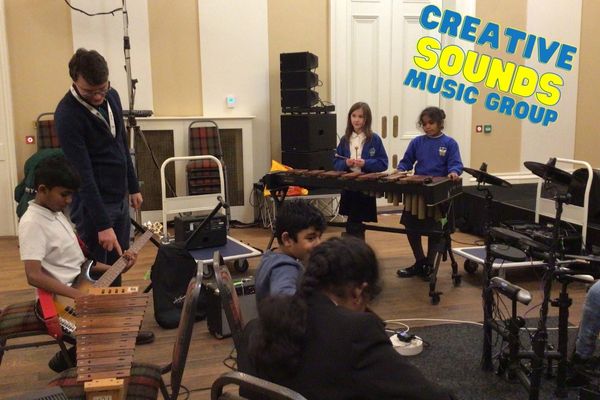 group of young children playing a range of musical instruments